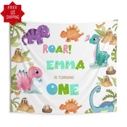 May include: A white dinosaur birthday banner with green, pink, blue, and orange dinosaurs. The banner reads 'Roar! Emma is turning one.'